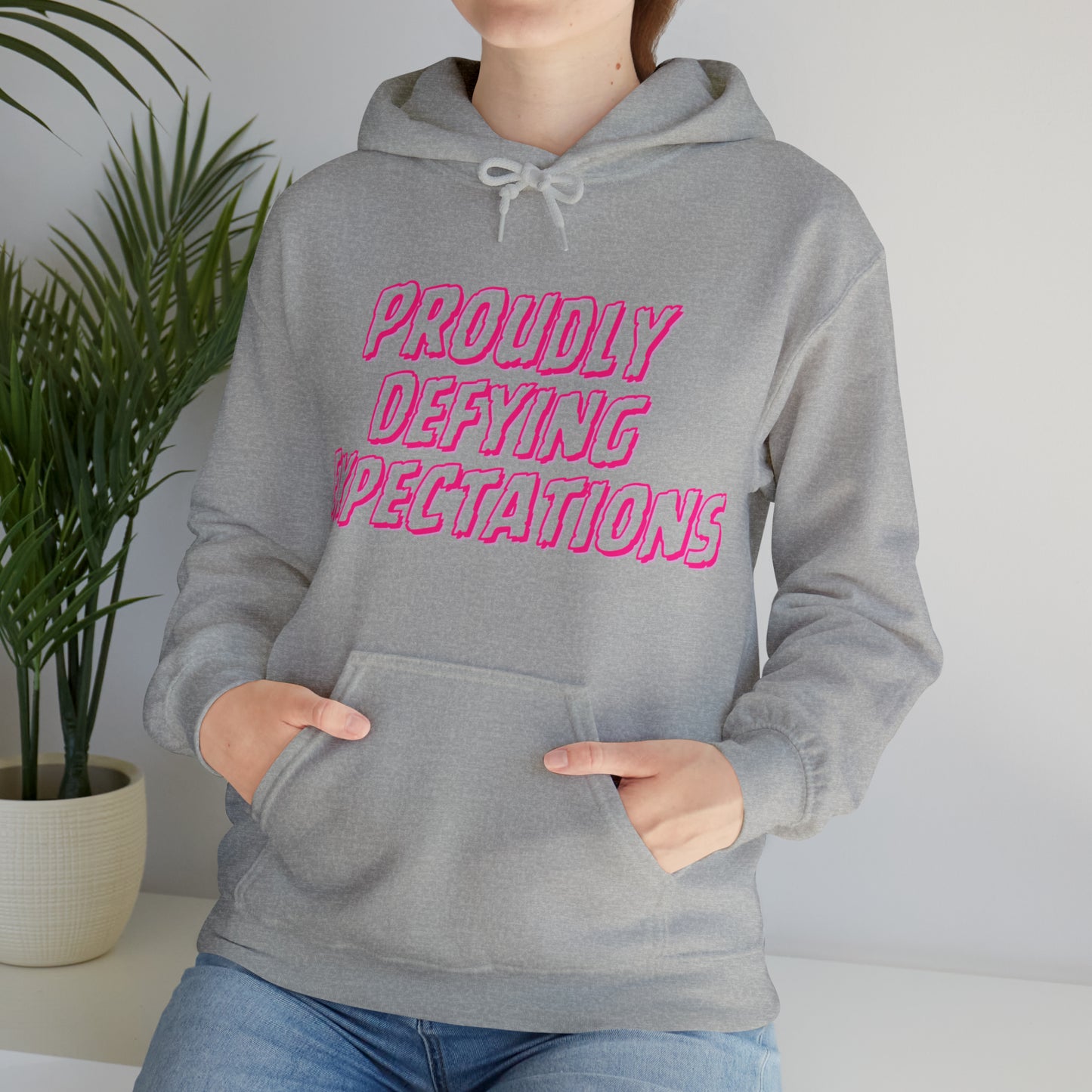 Unisex Hooded Sweatshirt - Proudly Defying Expectations